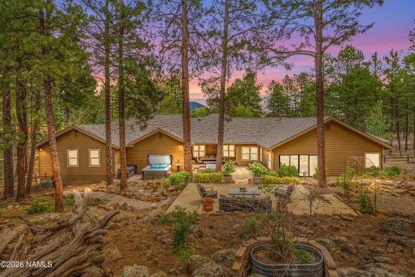 Resort-style backyard with hot tub, cold plunge, and custom rock fountains at 2963 N Boldt Dr in Flagstaff AZ
