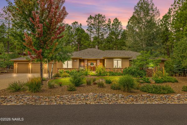 Exterior of luxury Flagstaff Arizona home for sale at 2963 N Boldt Dr in Linwood Heights, surrounded by forest on a private acre