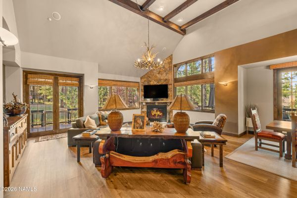 Great room with soaring cathedral ceilings and fireplace inside Pine Canyon luxury home, Flagstaff, AZ