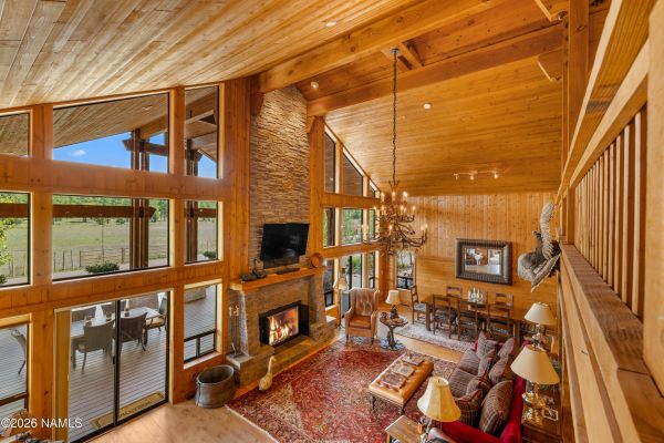Front deck and fire pit overlooking ten acres of pasture at a craftsman home on acreage in Parks, Arizona