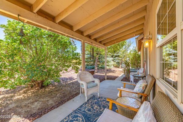 Backyard retreat in Flagstaff Arizona with scenic San Francisco Peaks views, outdoor porch space, open acreage, and peaceful country living atmosphere.