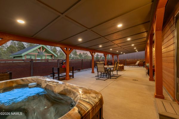 Outdoor living space with fire pit and hot tub on private mountain estate in Northern Arizona