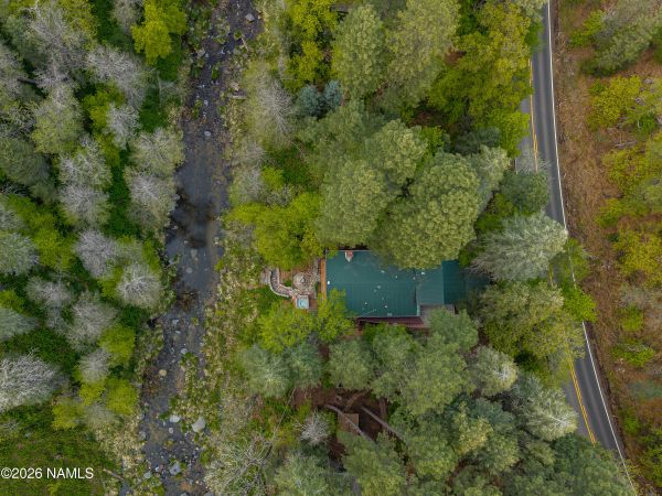 Private Oak Creek frontage behind Sedona home with peaceful outdoor living and natural canyon surroundings
