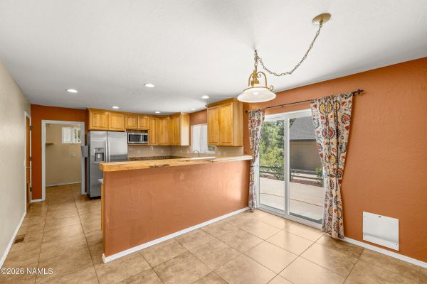 Remodeled kitchen with newer cabinets and countertops in a 4-bedroom Flagstaff, AZ home for sale