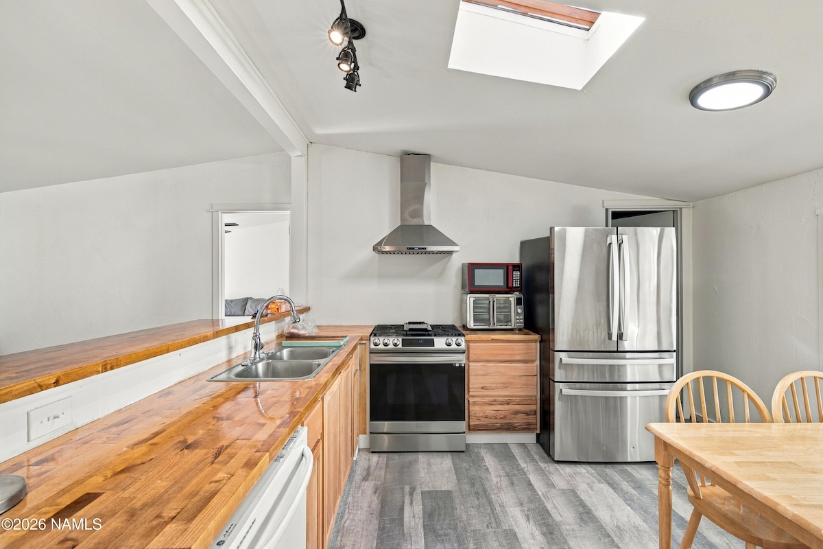 Refreshed kitchen with new counters, cabinets and Samsung gas range at 2196 W Alaska Ave, Flagstaff, AZ