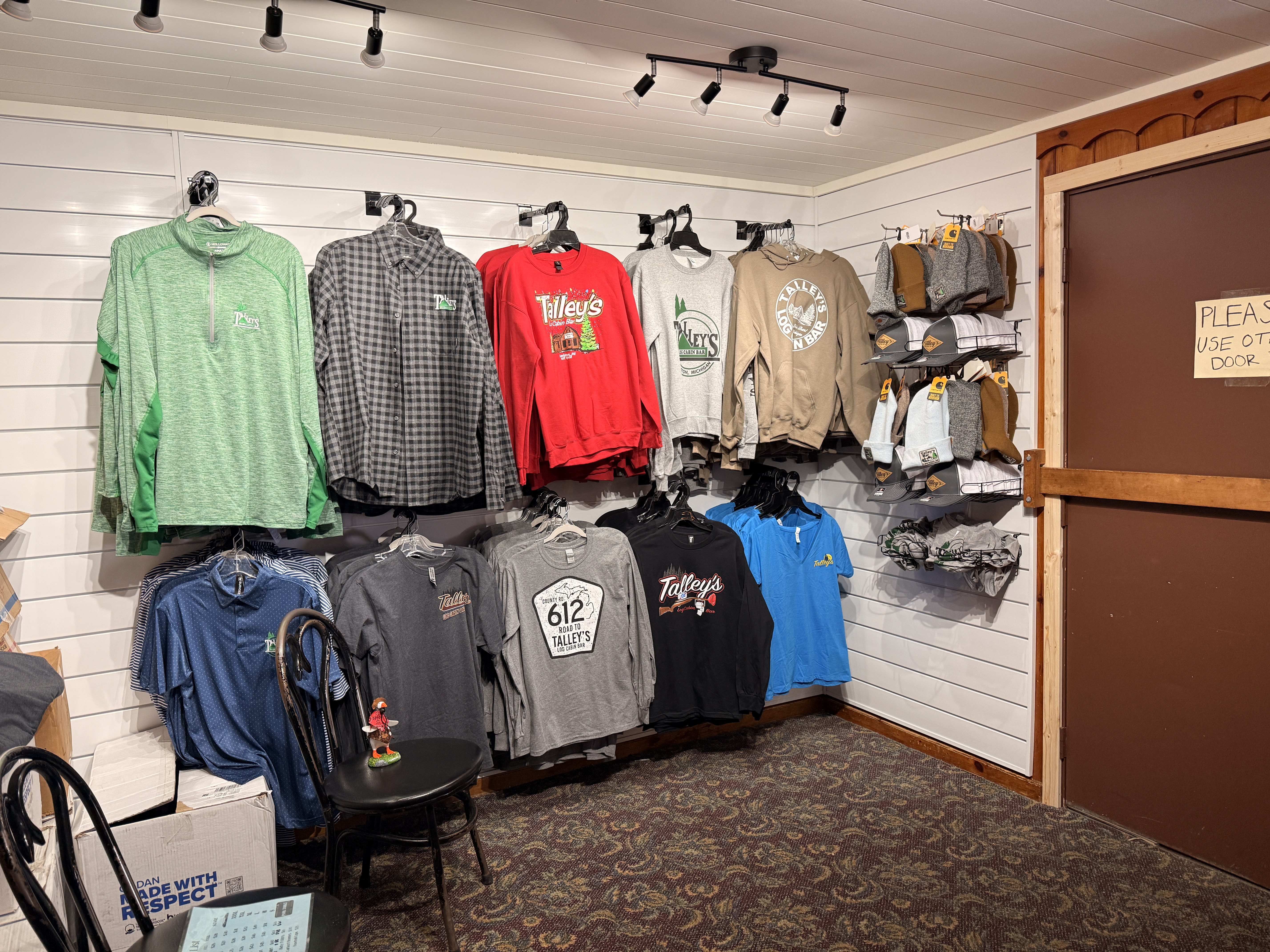 Hughie the Goose hidden at Talley's Log Cabin Bar merchandise display - Huston Real Estate