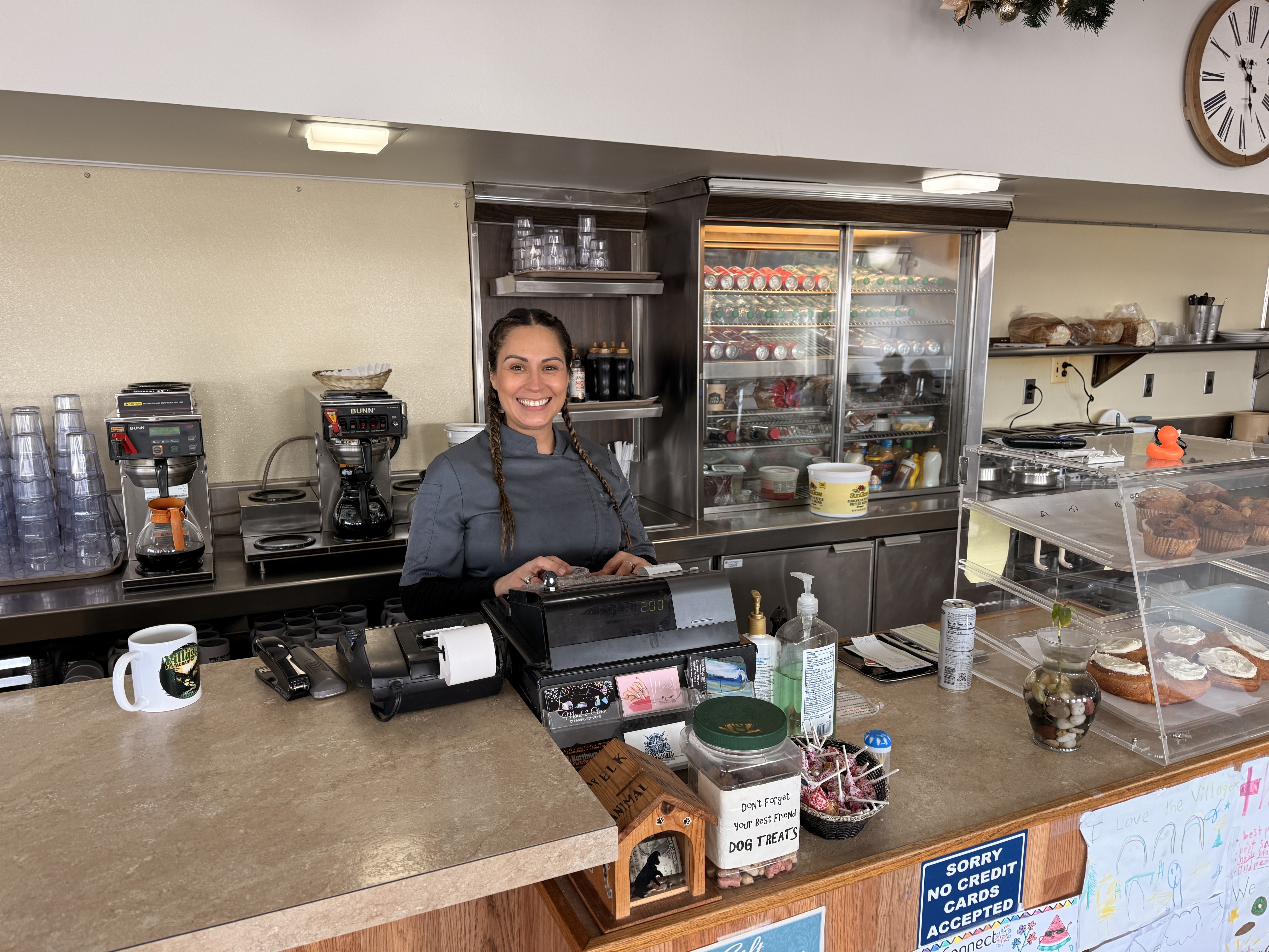 Aubrie, owner of The Villager Restaurant, behind the register in Lewiston, Michigan - Huston Real Estate