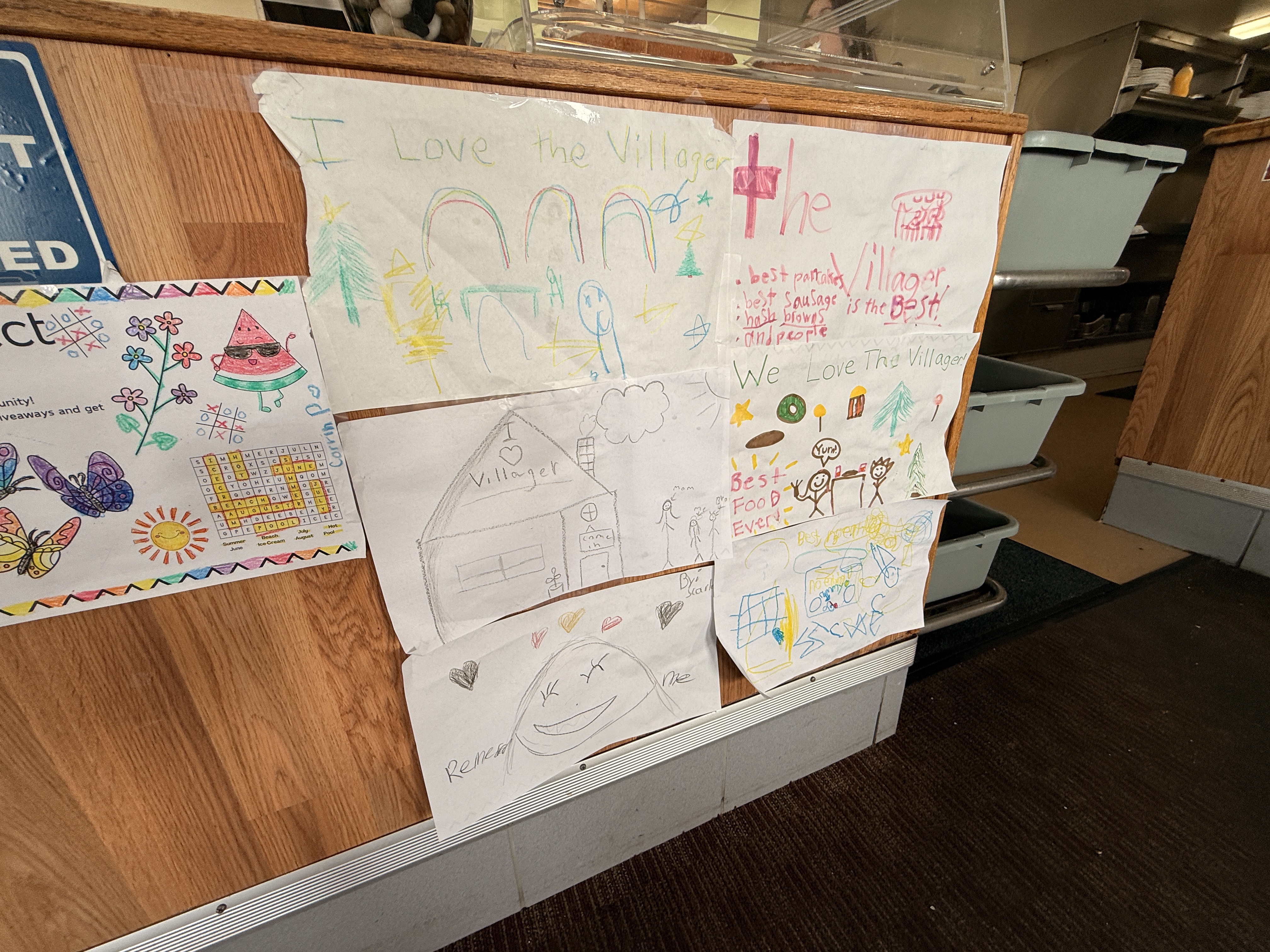 Children's drawings on placemats at The Villager Restaurant in Lewiston, Michigan showing love for the restaurant - Huston Real Estate