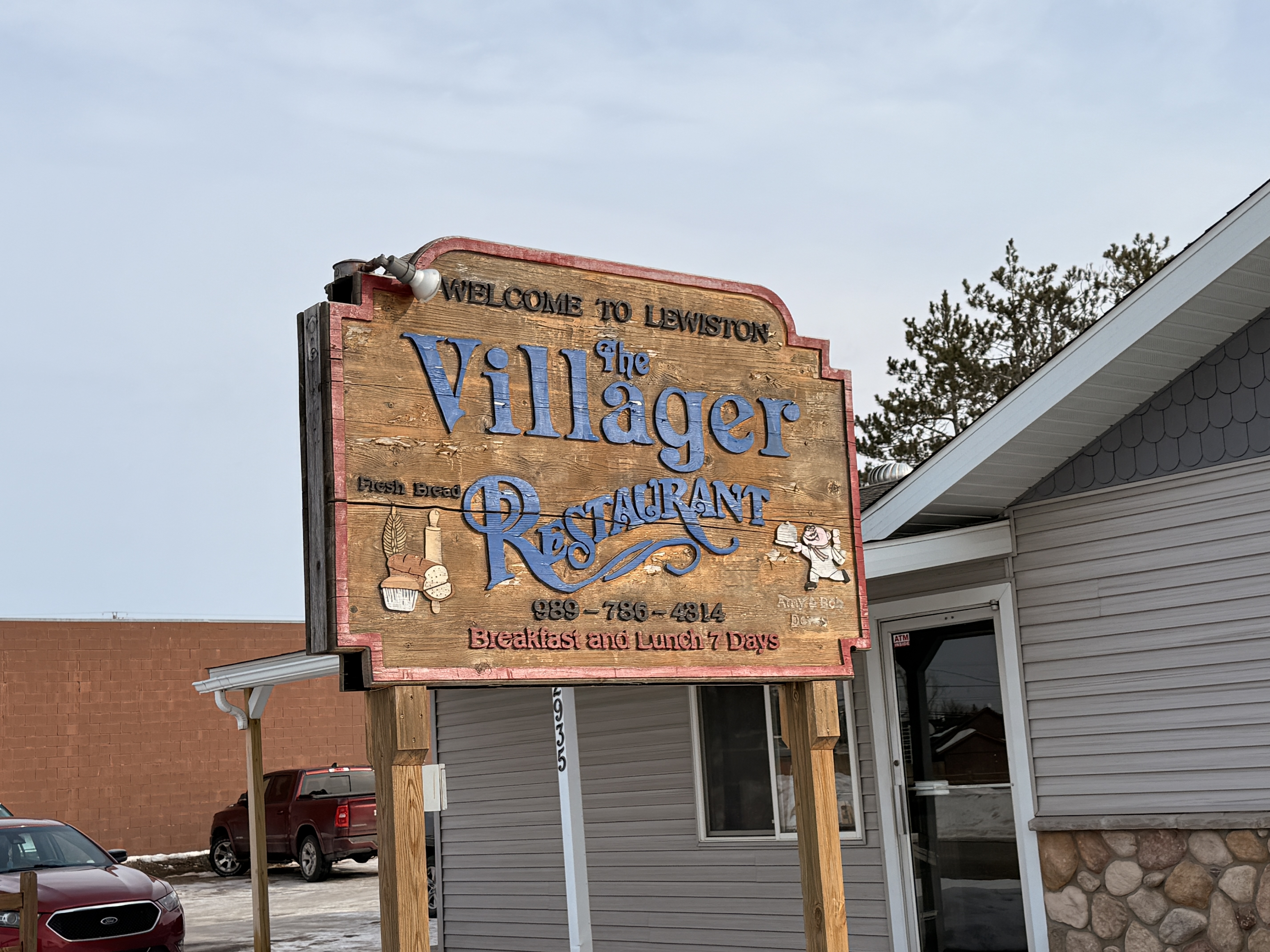 Close-up of The Villager Restaurant sign in Lewiston, Michigan - Huston Real Estate
