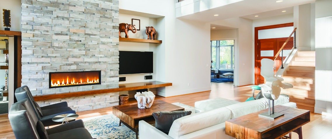 Open living room with a stone fireplace