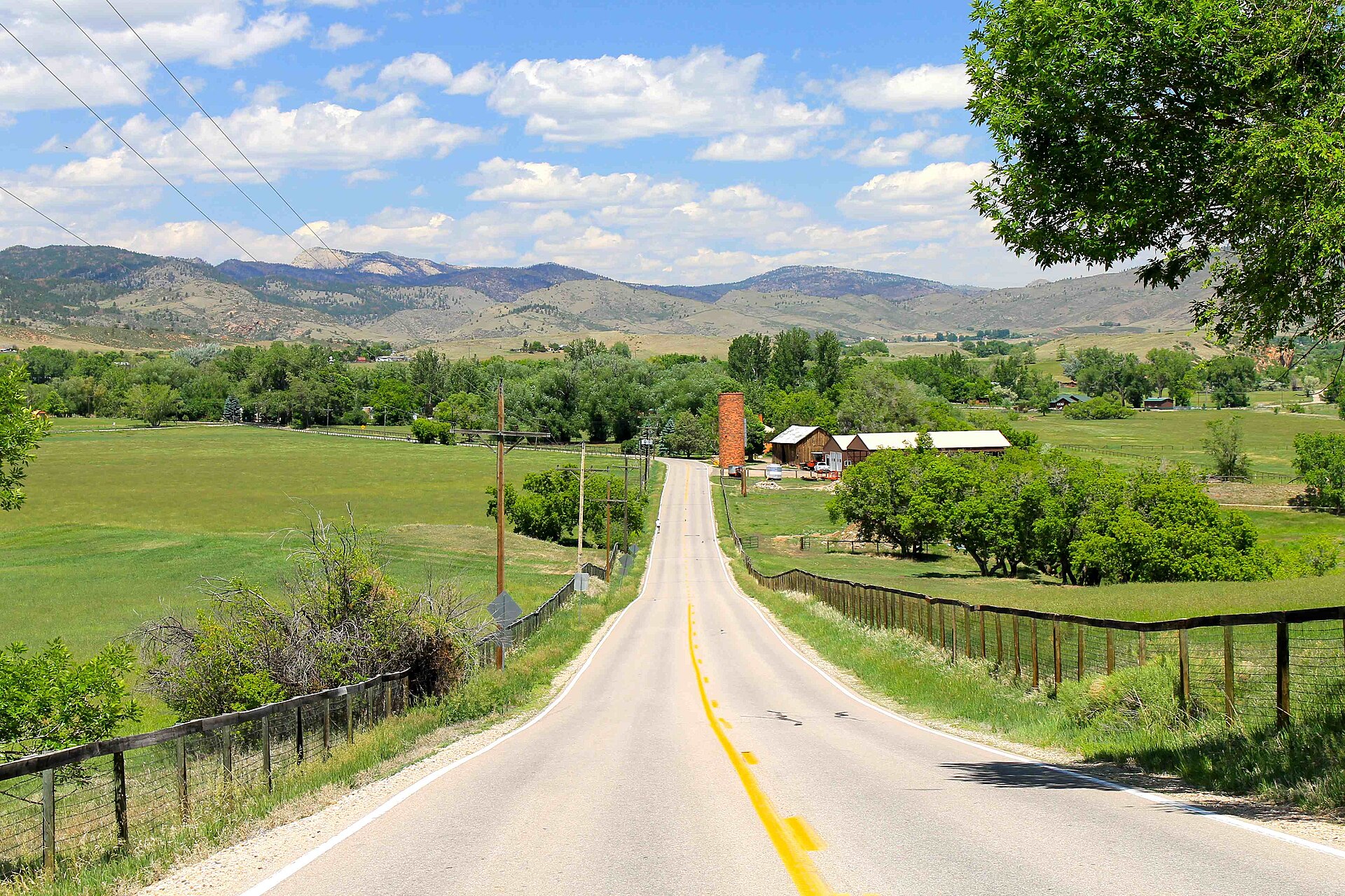 Country road through Pleasant Valley near Bellvue with farmland and foothills