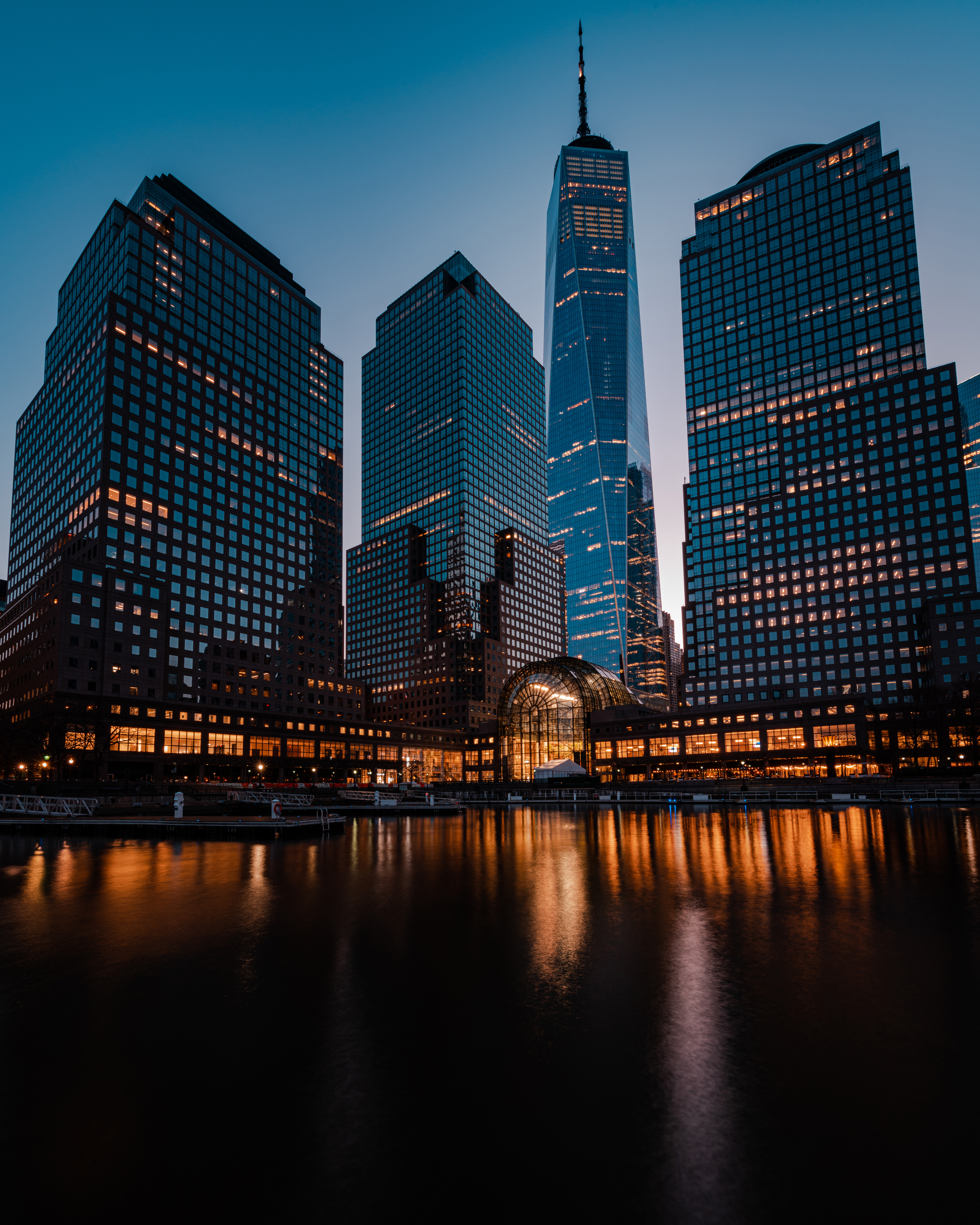 ne World Trade Center and Brookfield Place waterfront at dusk