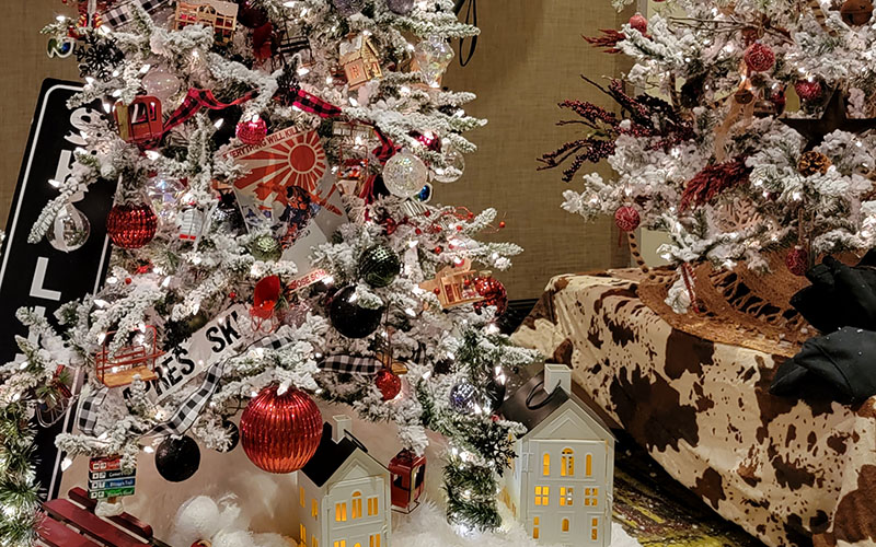 Decorated Christmas trees at an indoor holiday exhibition