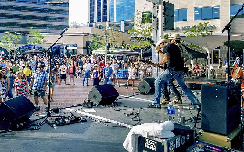 Outdoor plaza concert crowd on a summer evening