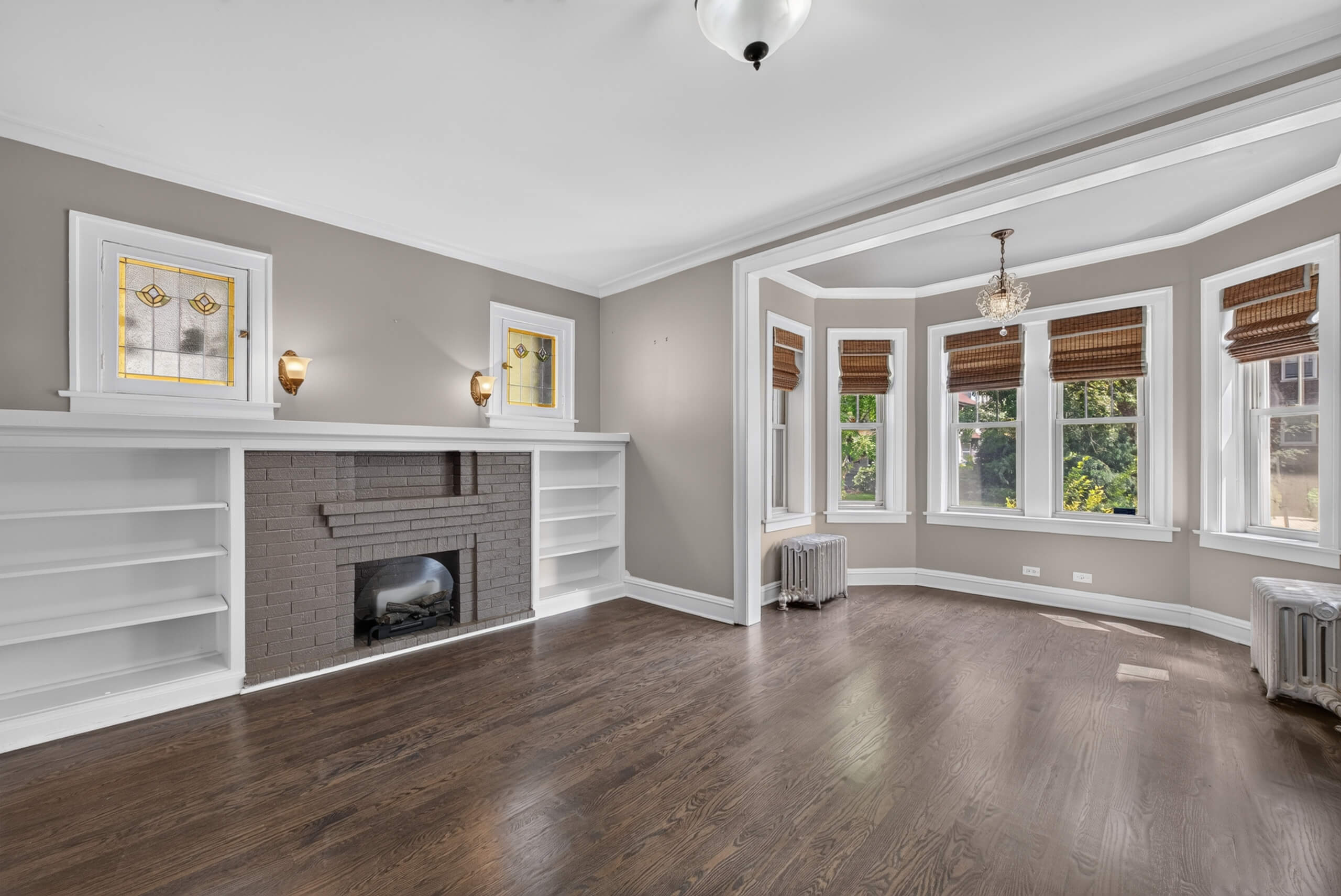 Vintage living room at 845 S Humphrey Avenue Unit 1 in Oak Park with decorative fireplace, built-ins and adjoining sunroom