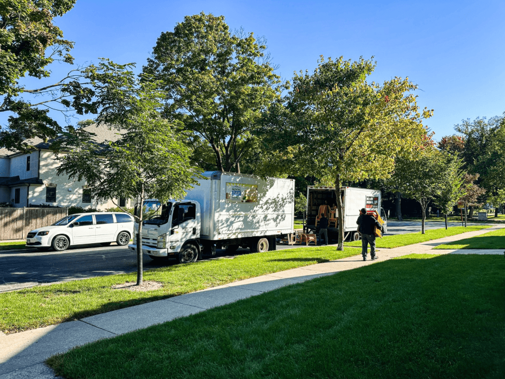 Day two with Moving Day Ready and Metro Junk Removal: three truckloads of furniture, books, and art headed for donation, while the sorting and packing continue inside.
