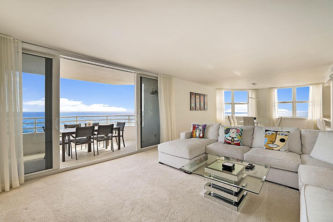 Open living and dining area with floor-to-ceiling impact glass