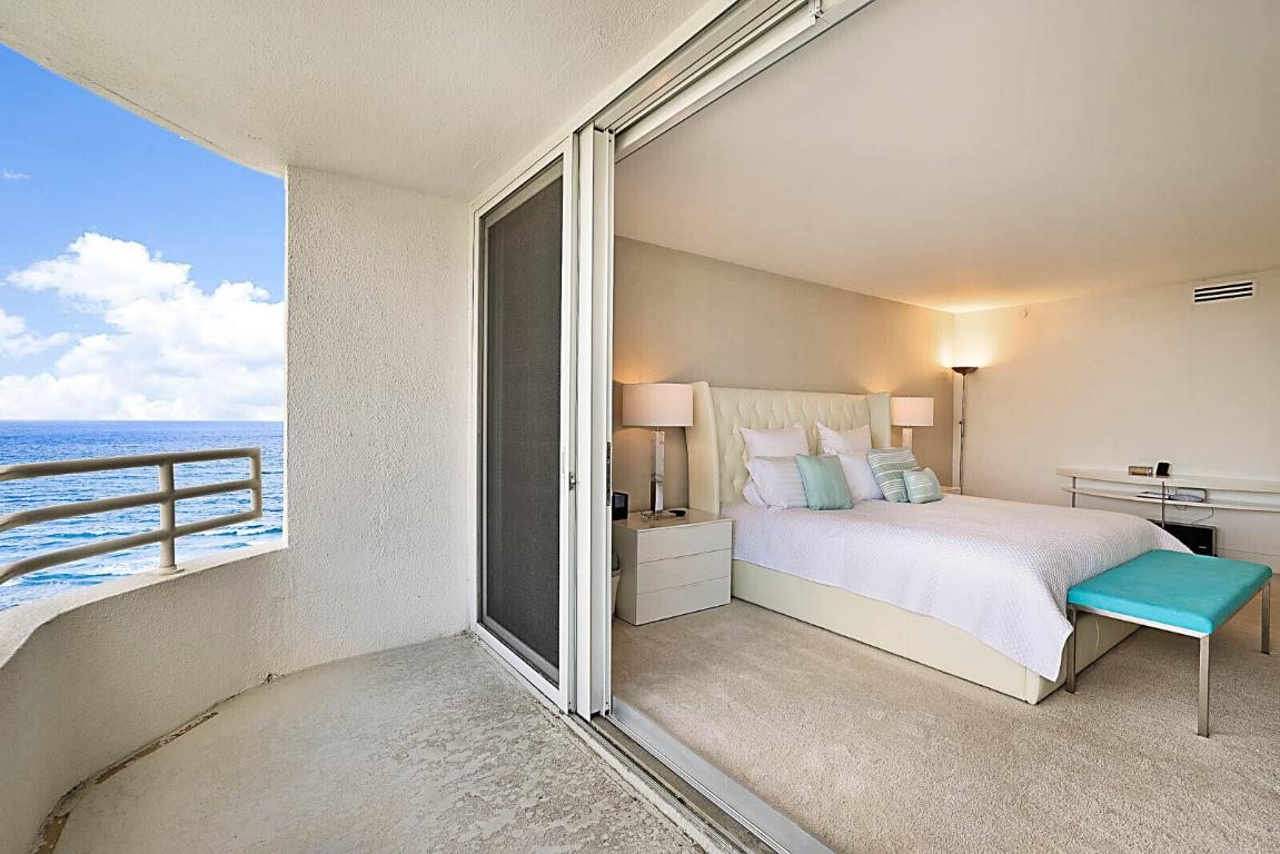 Bedroom with direct ocean views and balcony access