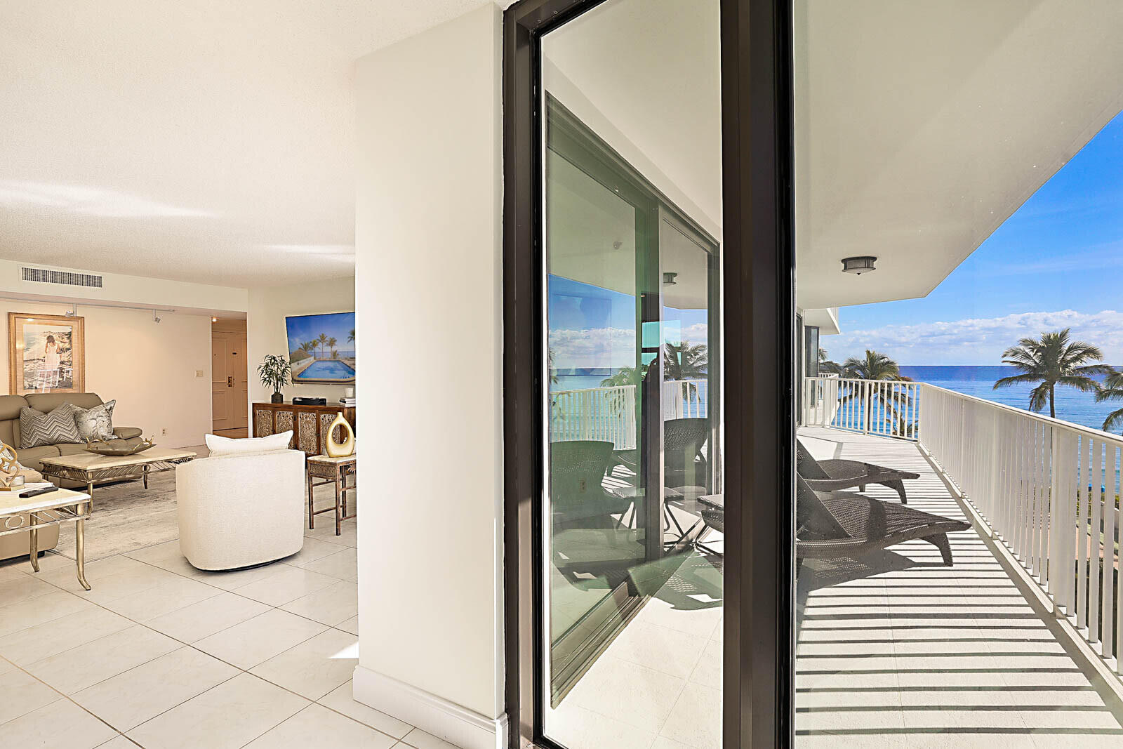 Living room with ocean-view balcony at 2917 S Ocean Blvd #405