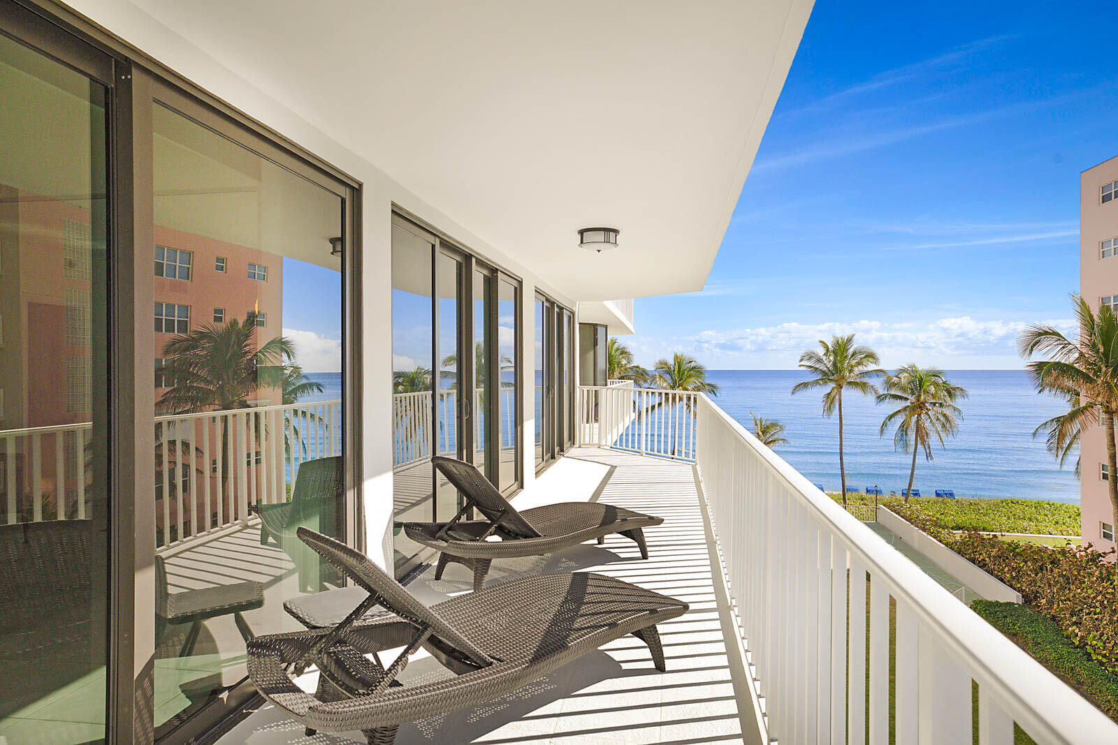 Private oceanfront balcony with lounge seating