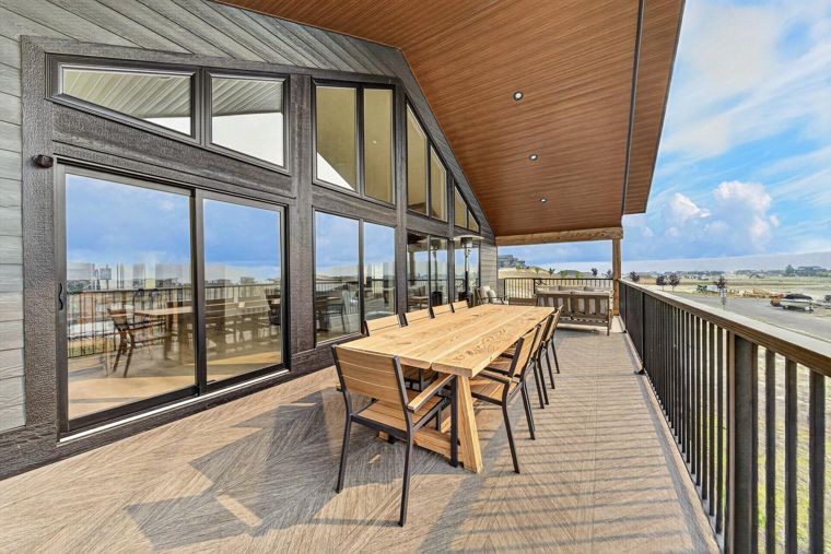 Outdoor dining table on the covered deck at 1731 Marina Estates Road