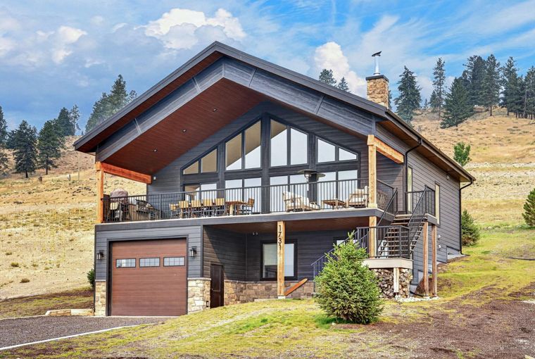 Front exterior showing the covered deck and garage at 1731 Marina Estates Road