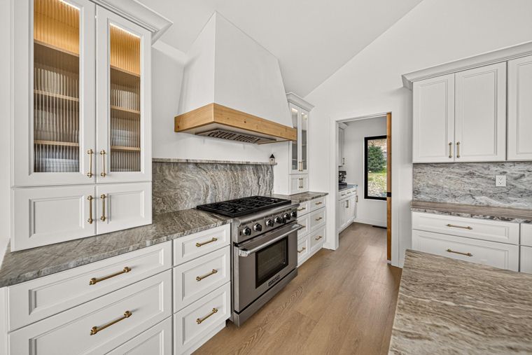 Kitchen range and glass-front upper cabinets at 1731 Marina Estates Road