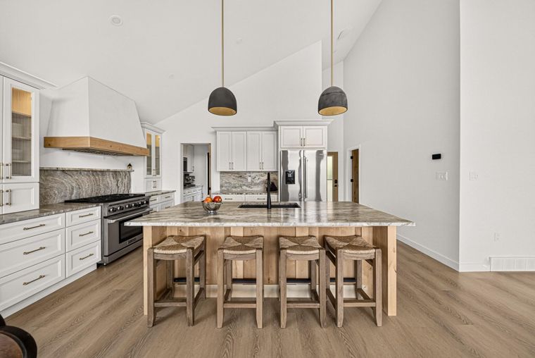 Kitchen island, range and white cabinetry at 1731 Marina Estates Road