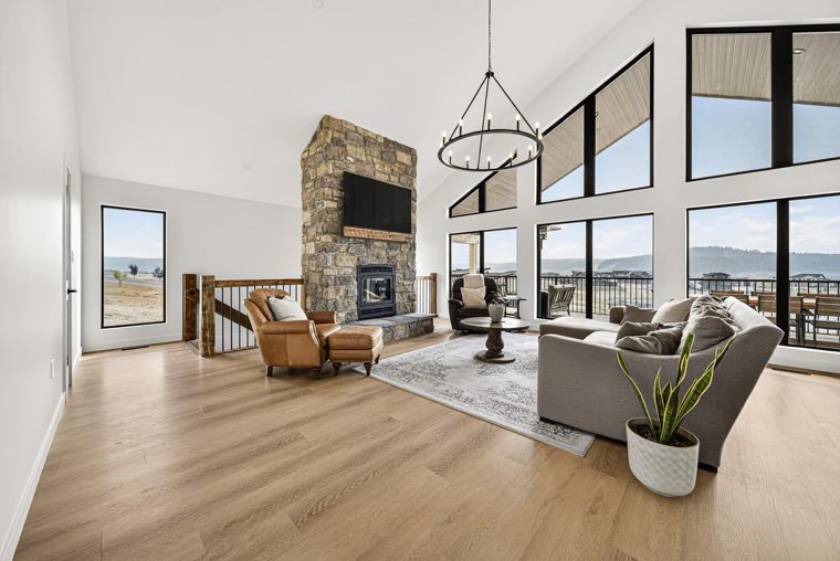 Living room with tall lake-facing windows at 1731 Marina Estates Road