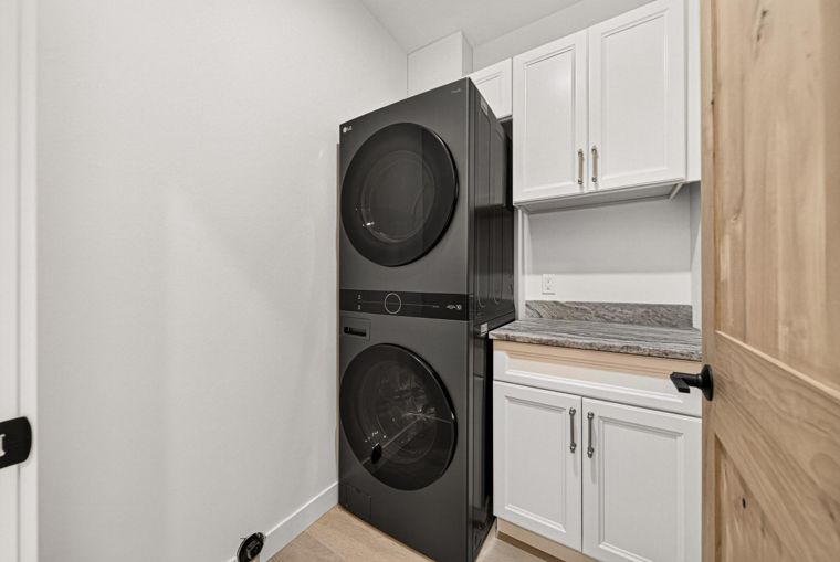 Laundry space with stacked washer and dryer at 1731 Marina Estates Road