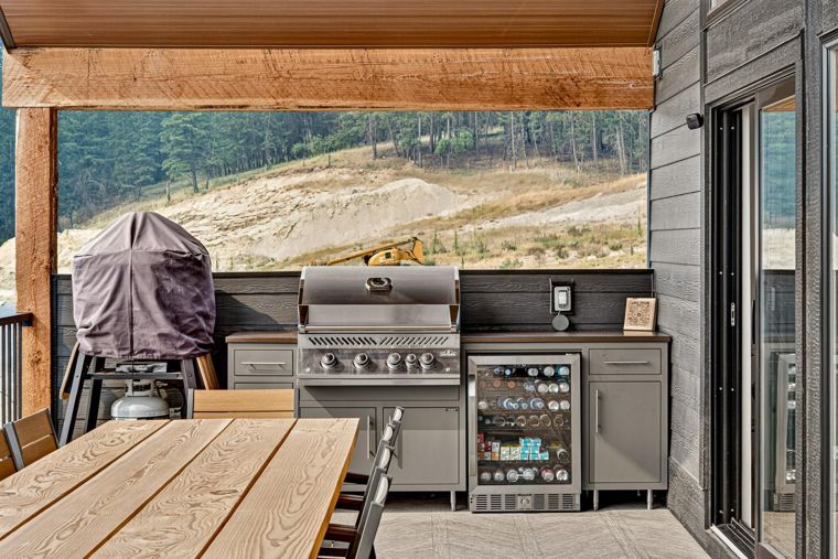 Outdoor kitchen with a grill, beverage fridge and pizza oven at 1731 Marina Estates Road