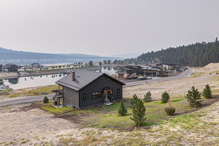 Rear exterior with Lake Koocanusa beyond at 1731 Marina Estates Road