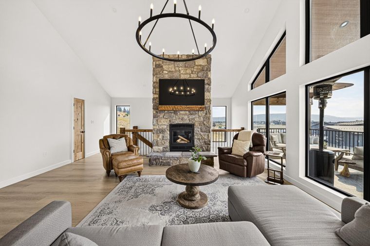 Open living room and full-height stone fireplace at 1731 Marina Estates Road