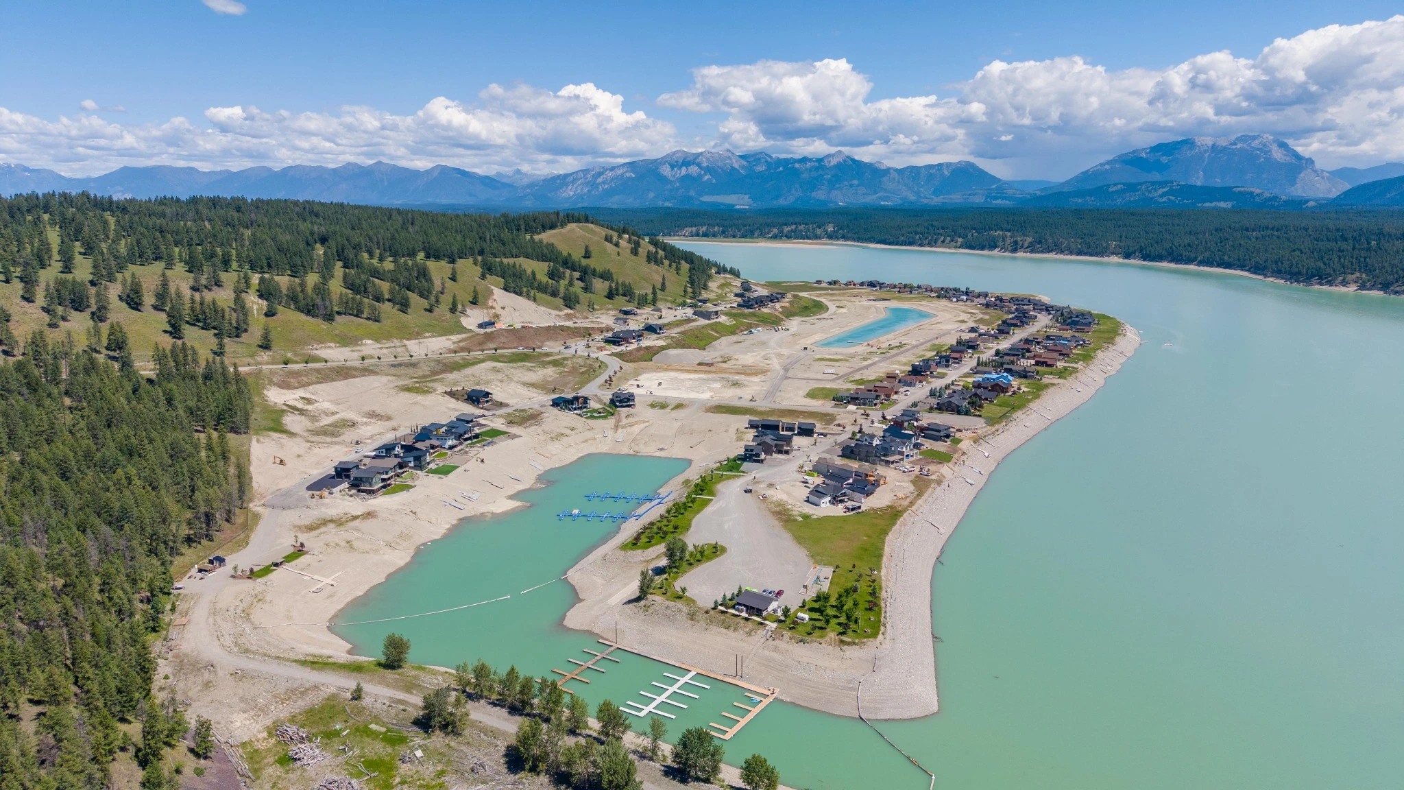 Aerial view of Koocanusa Village beside Lake Koocanusa and the mountains