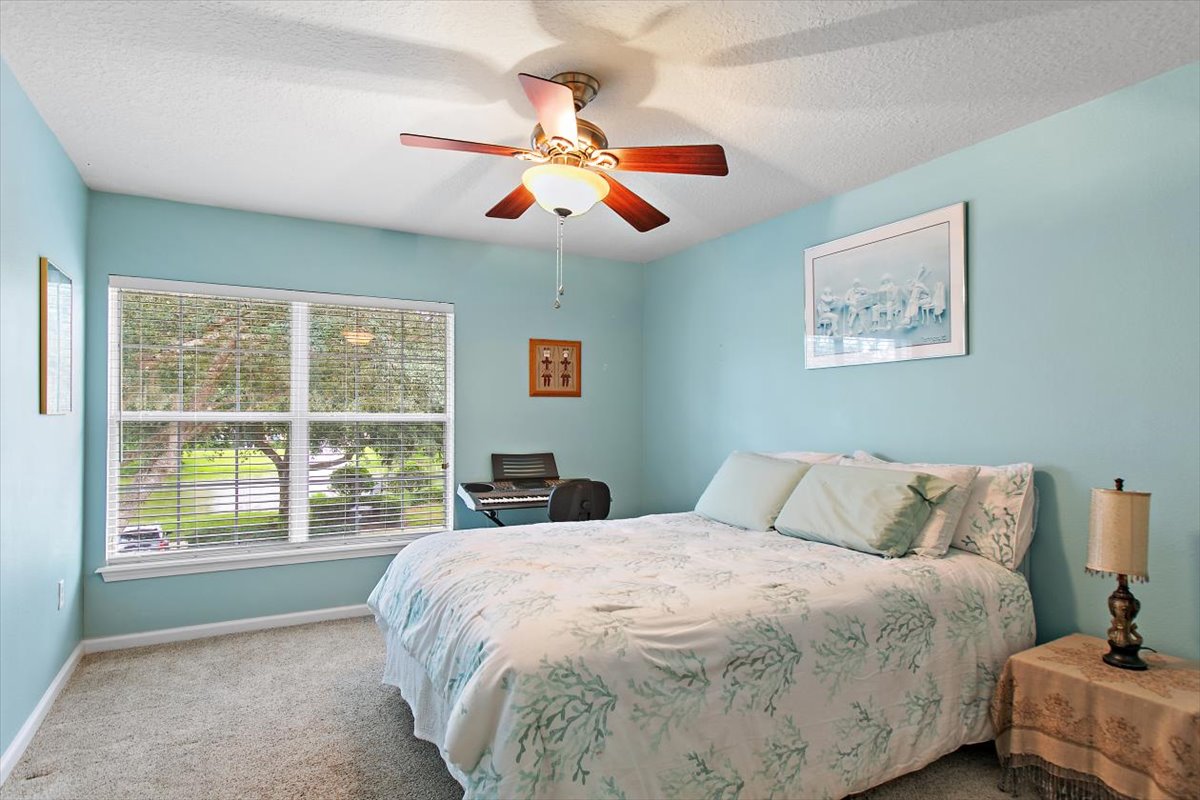 Guest bedroom with pond-facing windows at 8555 Little Swift Circle in The Tides at Sweetwater