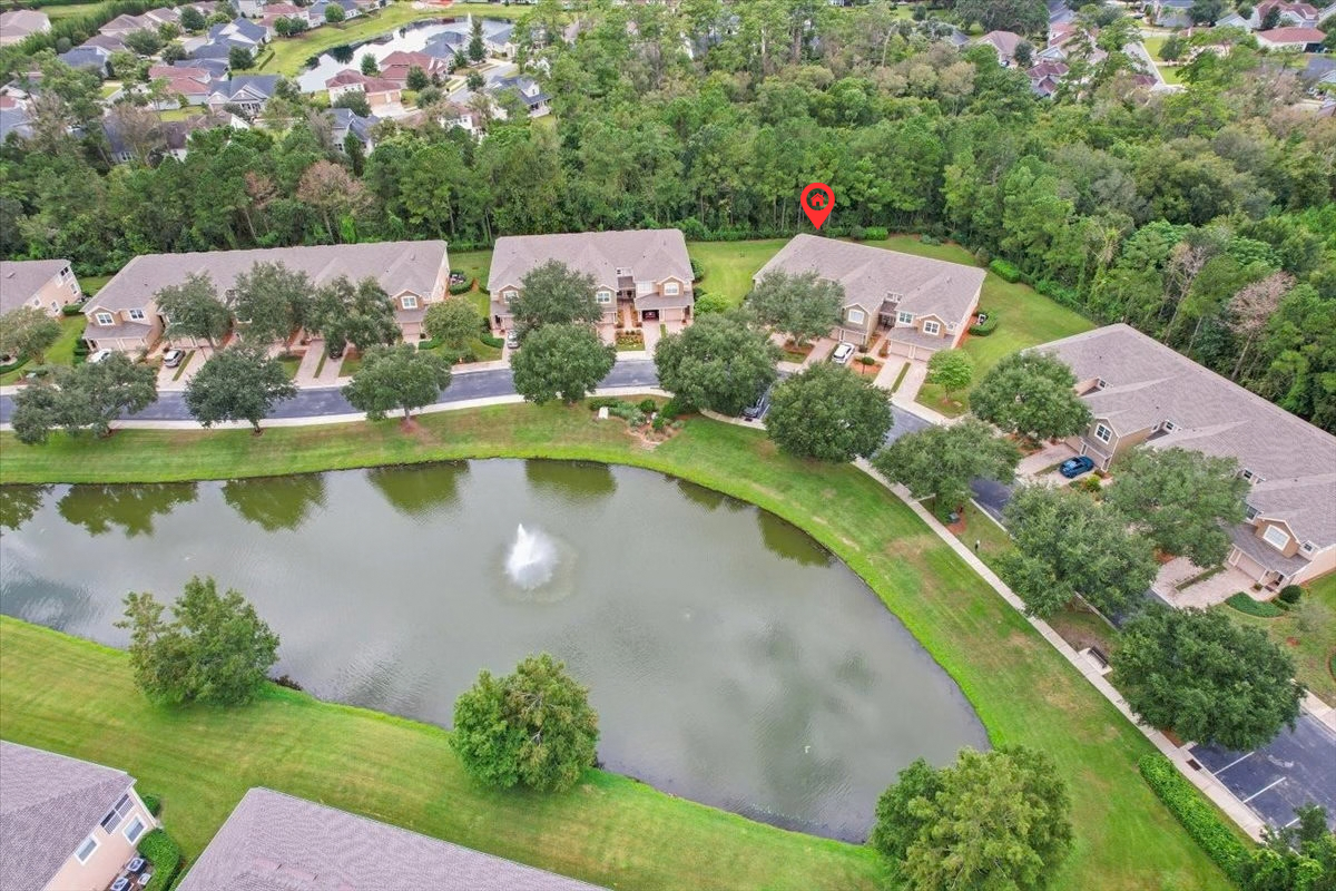Aerial view showing 8555 Little Swift Circle and the nearby pond in The Tides at Sweetwater by Del Webb, Jacksonville Florida