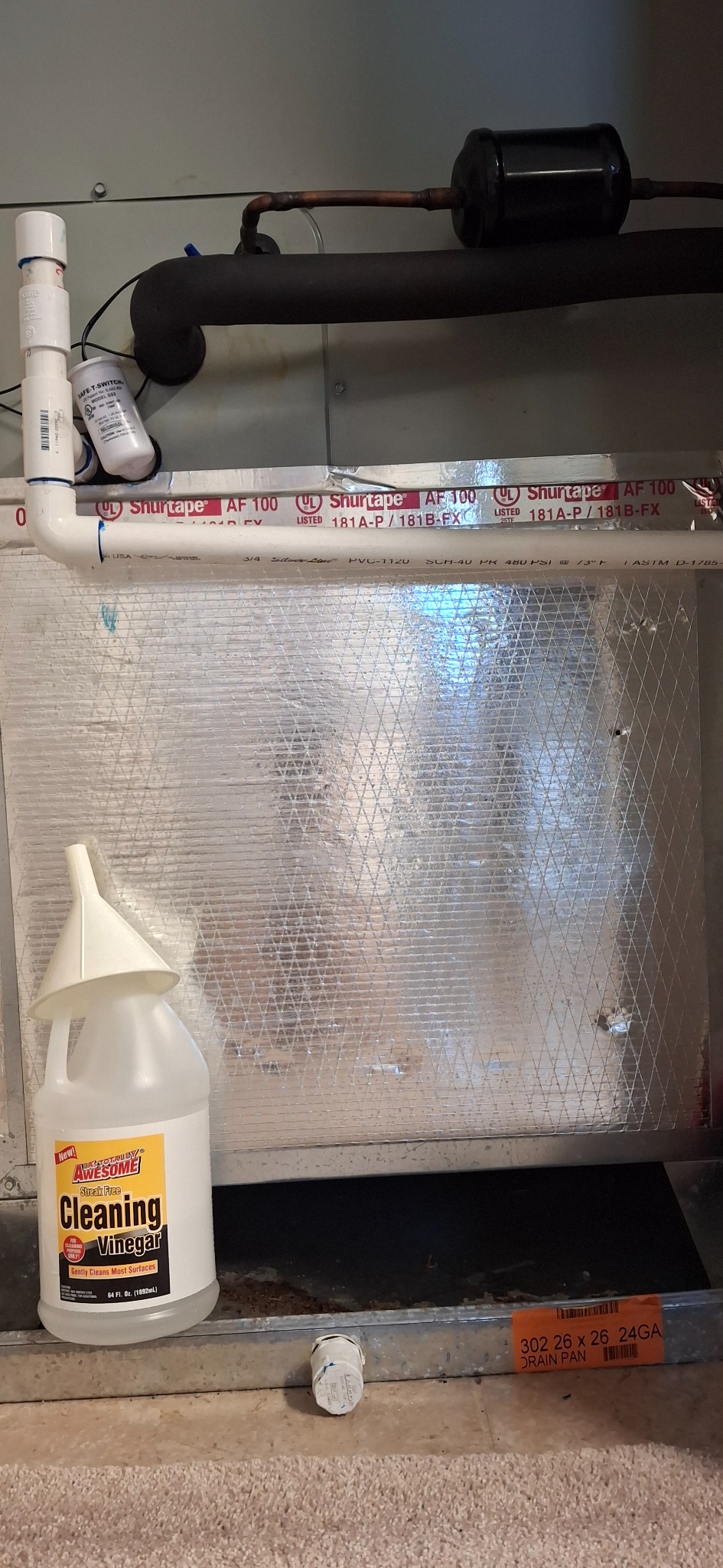 AC air handler condensate drain line and cleaning vinegar in a Florida home