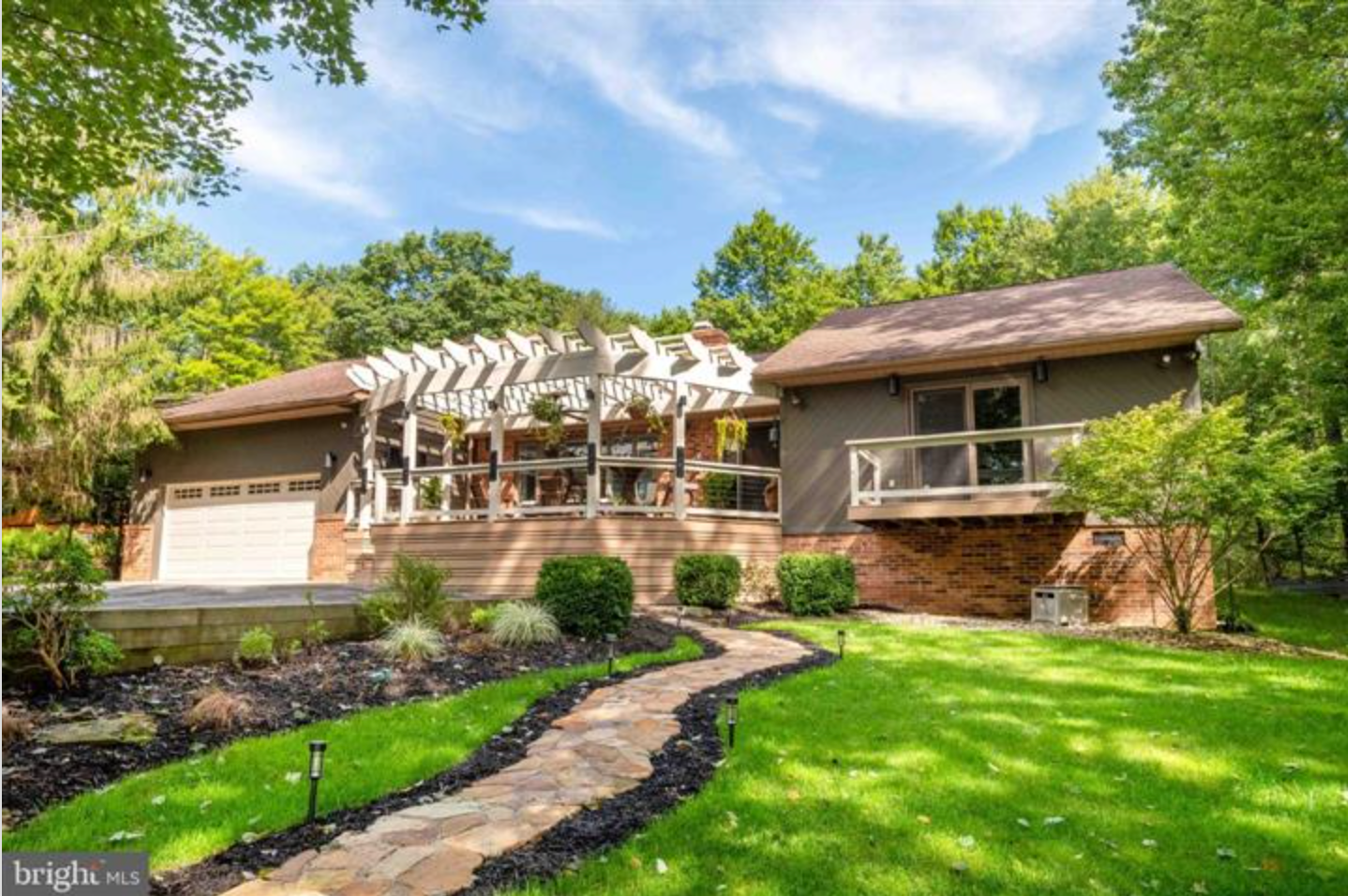 Exterior of the sold home at 1001 Penn Point Road, with a landscaped walkway and pergola-covered deck.
