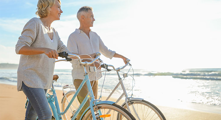 Two people walking bikes