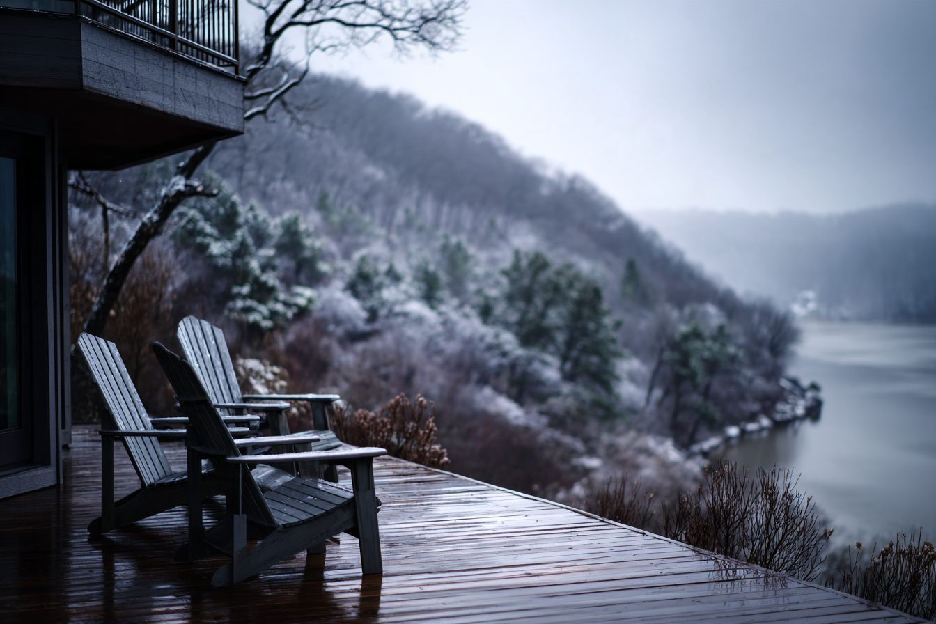Adirondack chairs on a lake home deck above frosted Ozark hills on a winter morning