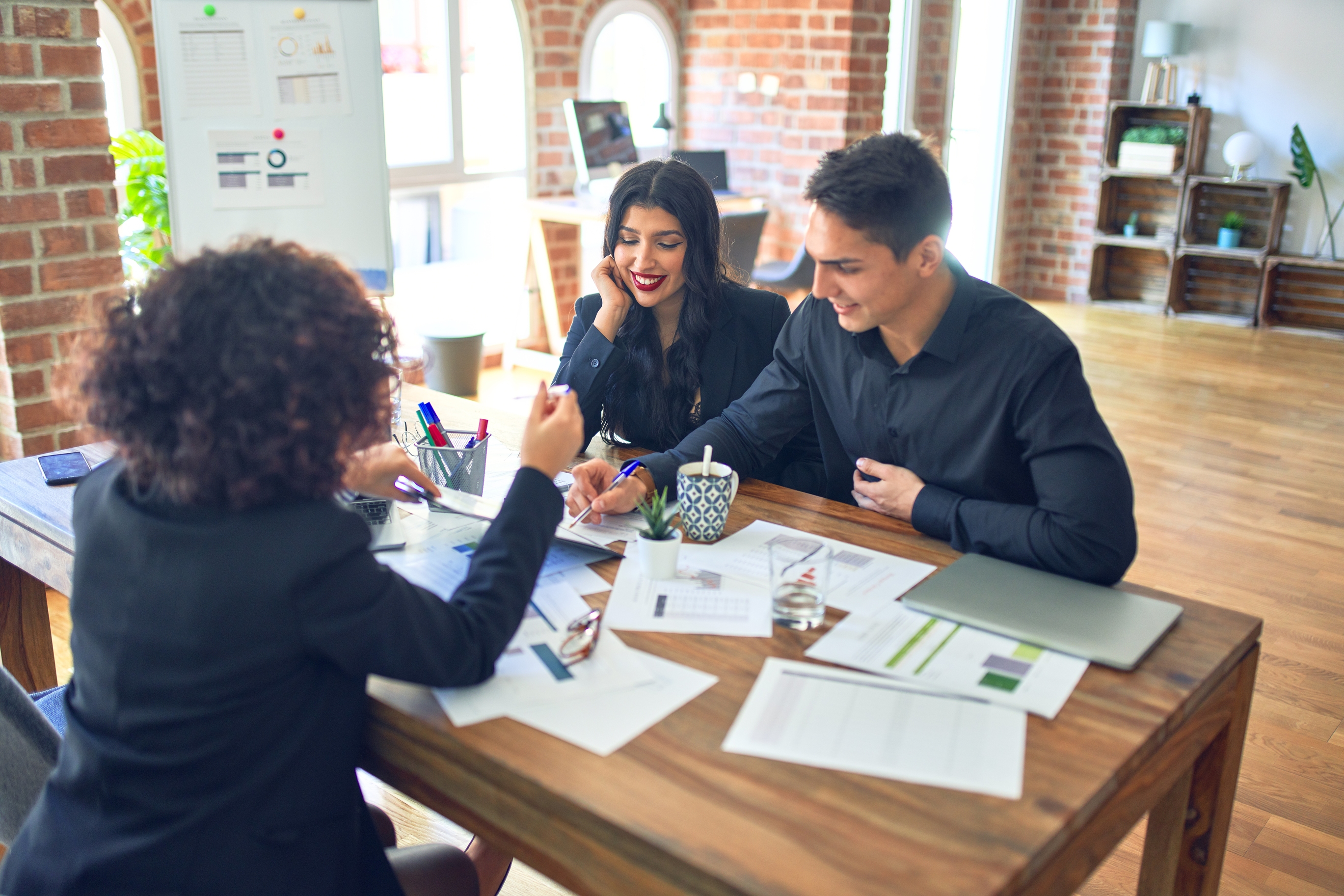 Happy home buyers beginning the mortgage pre-qualification process online