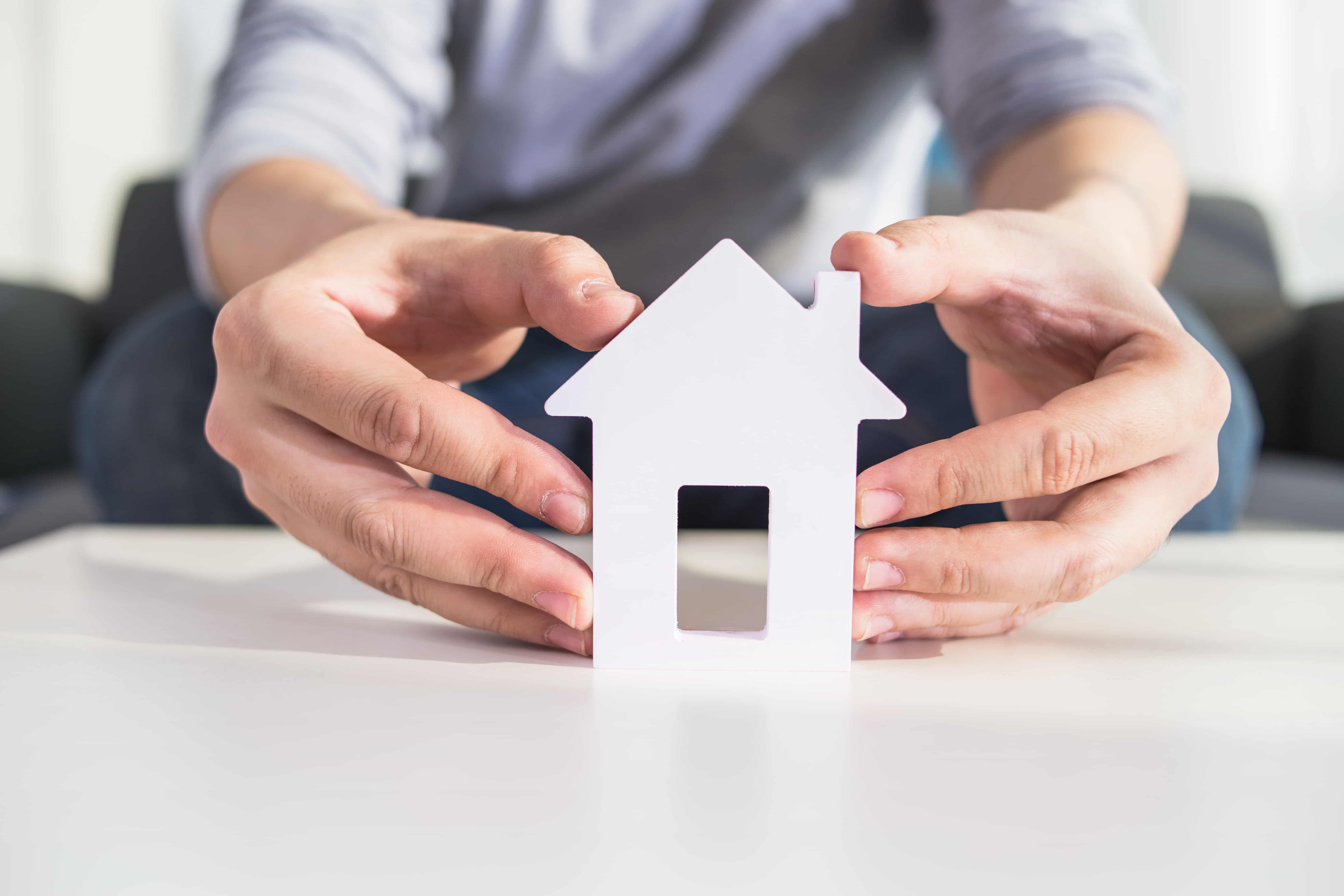 Man holding a dream house model