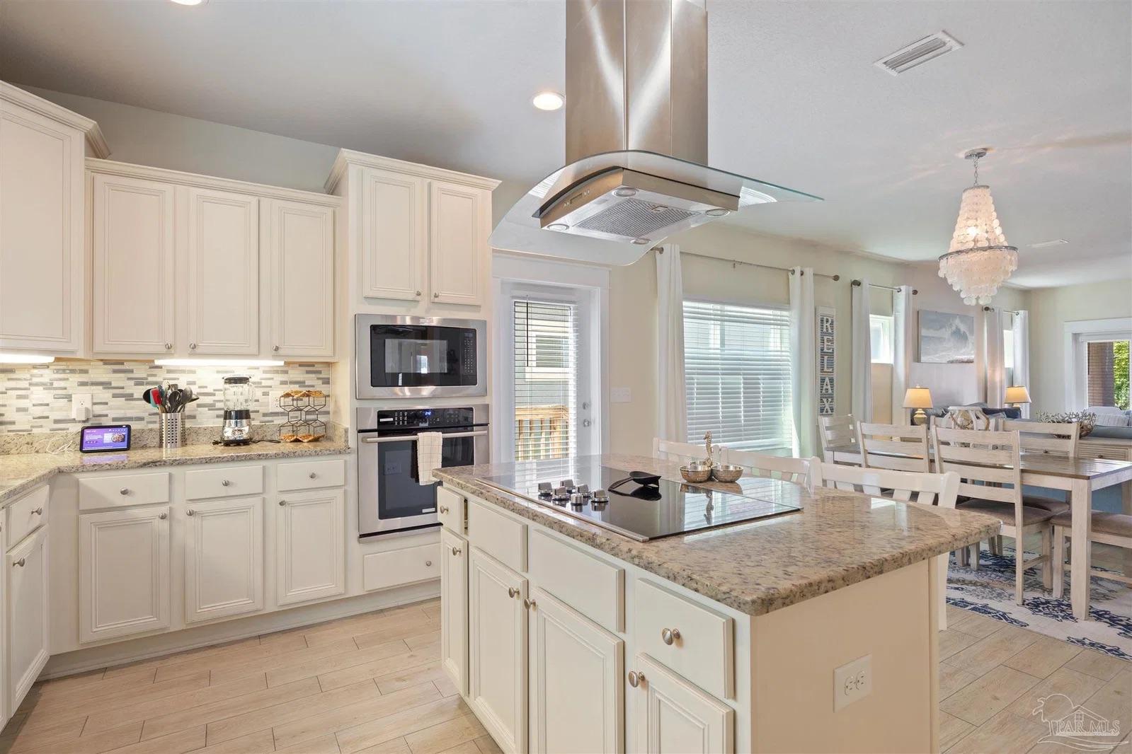Kitchen with granite countertops and stainless steel appliances at 13987 Hanging Branch Way