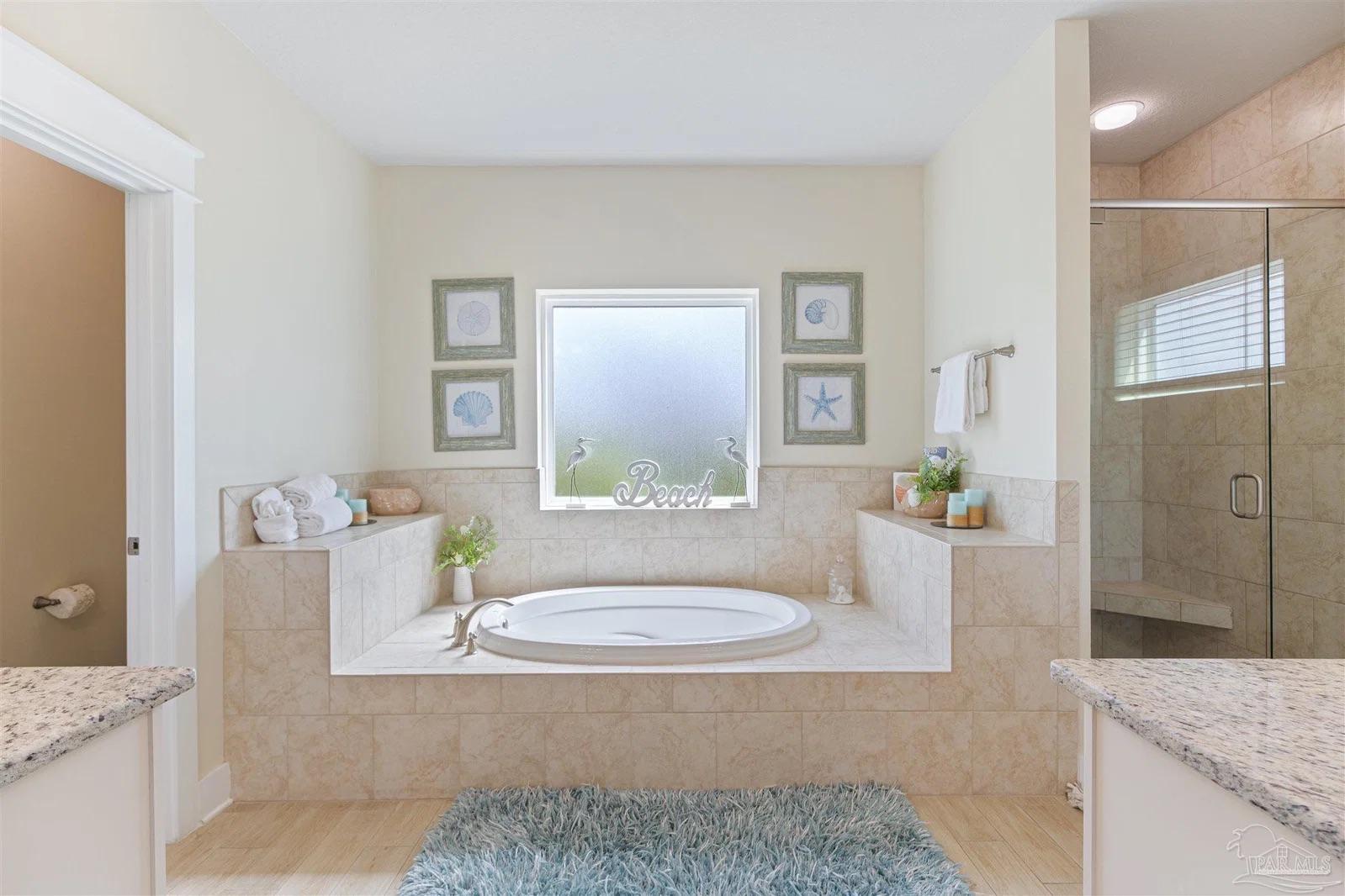 Primary bathroom with soaking tub at 13987 Hanging Branch Way