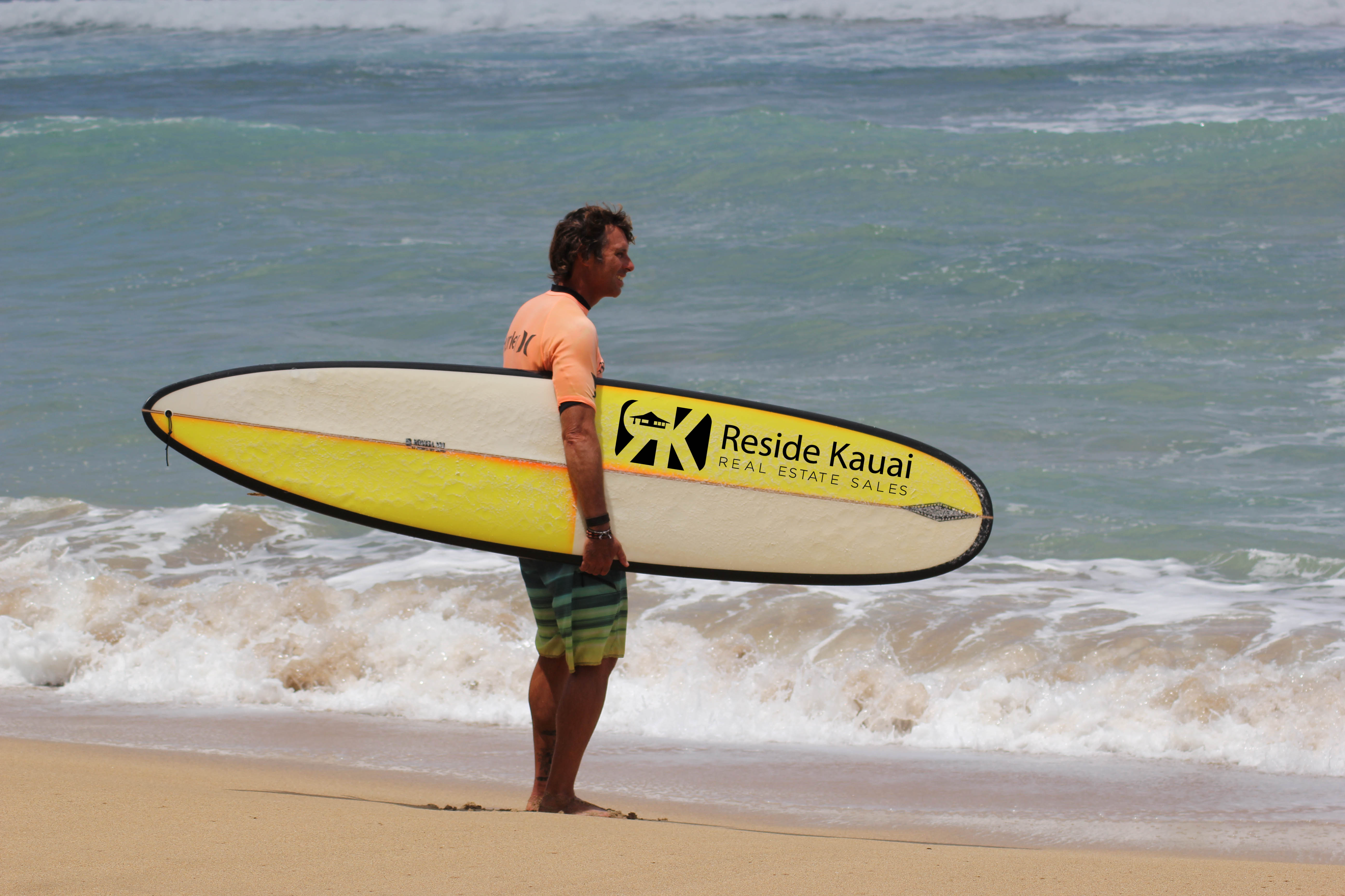 Surfer checking out the beach break on kauai.