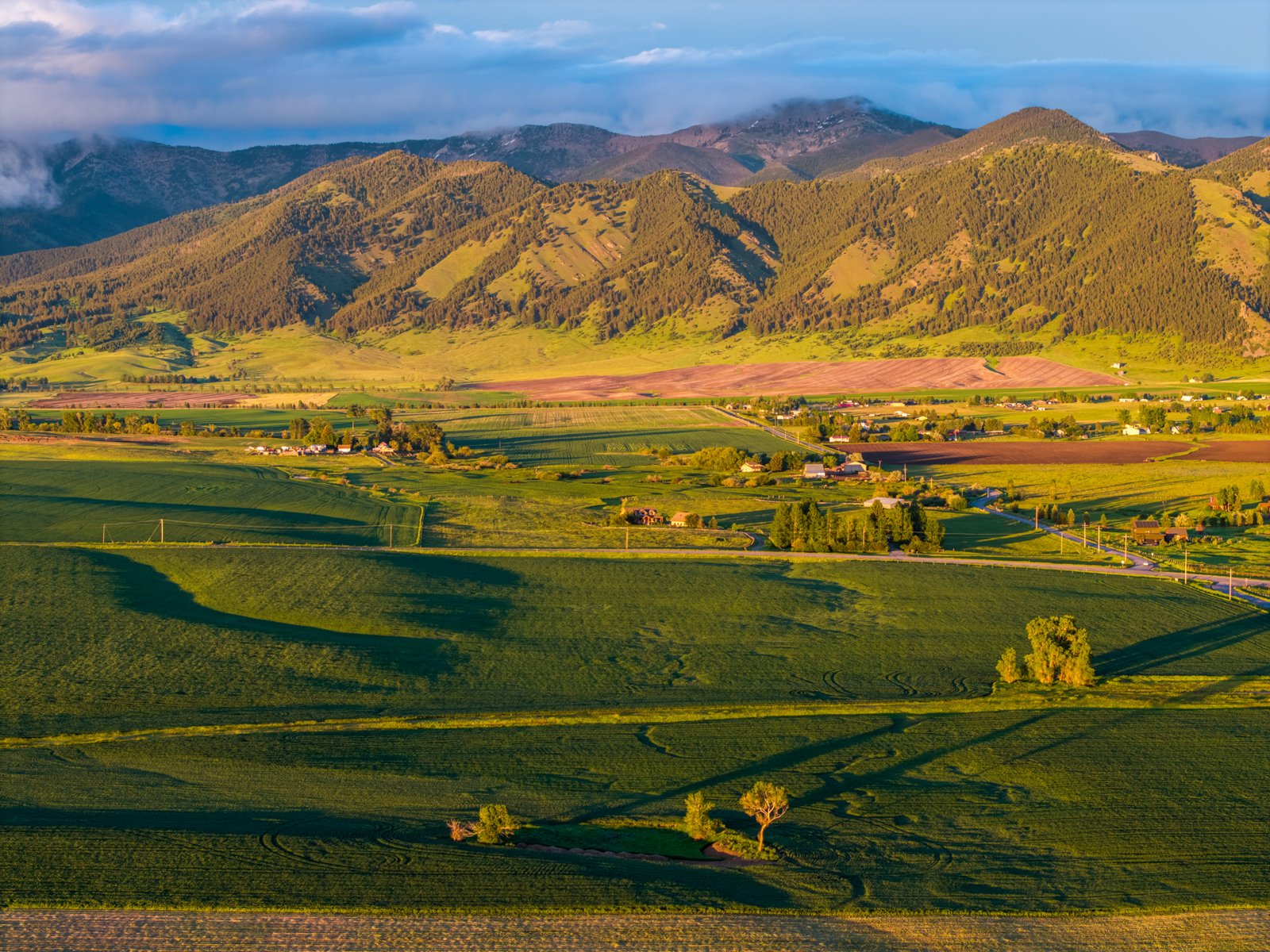 Drone view across the Penwell Bridge Road acreage toward the Bridger Mountains