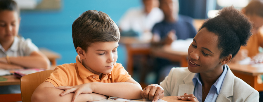 Eaton Academy - Teacher Helping Student