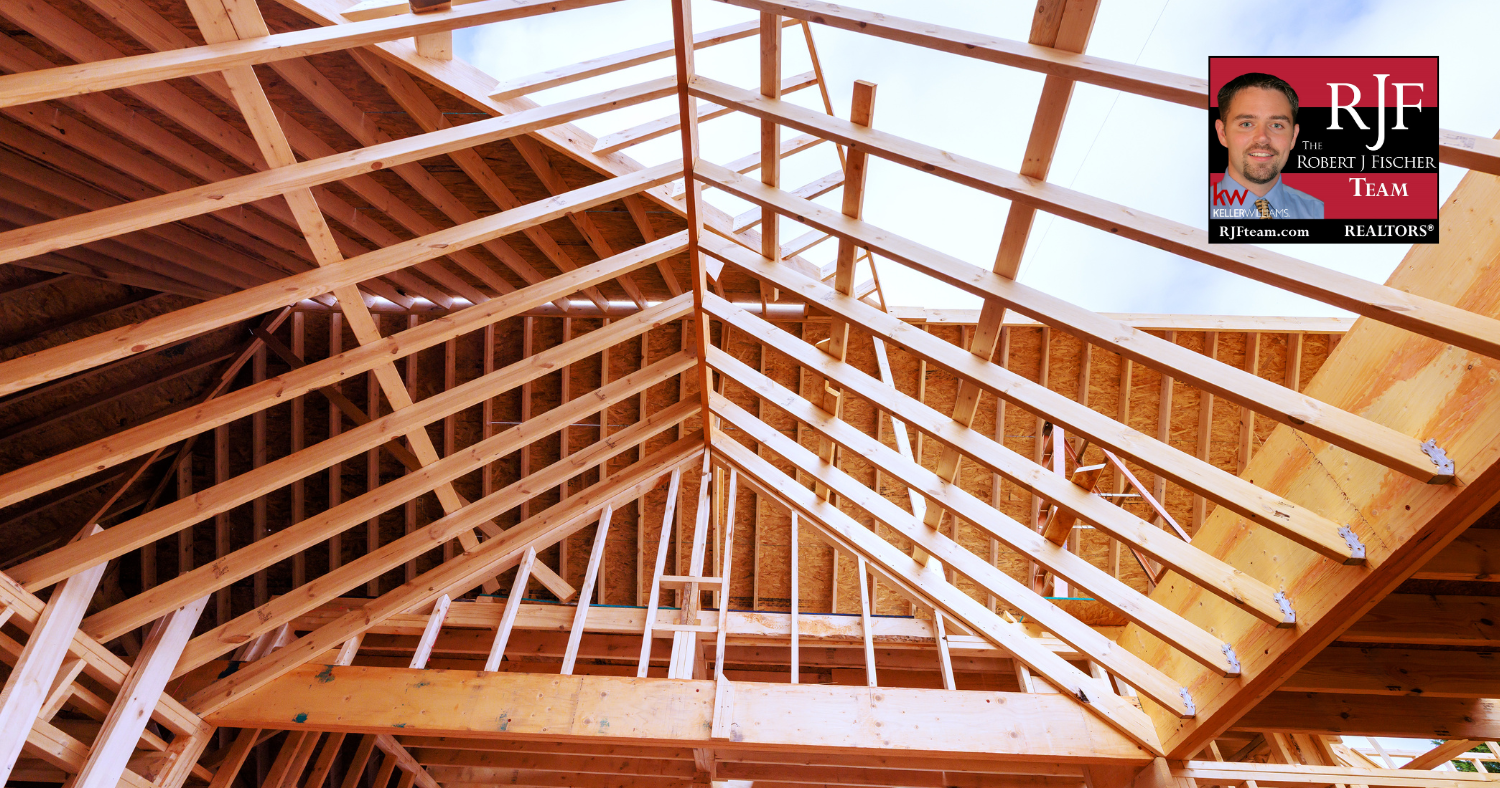 A photo of a home hat is being built - new construction. The Robert J Fischer Team logo is in the upper right corner.
