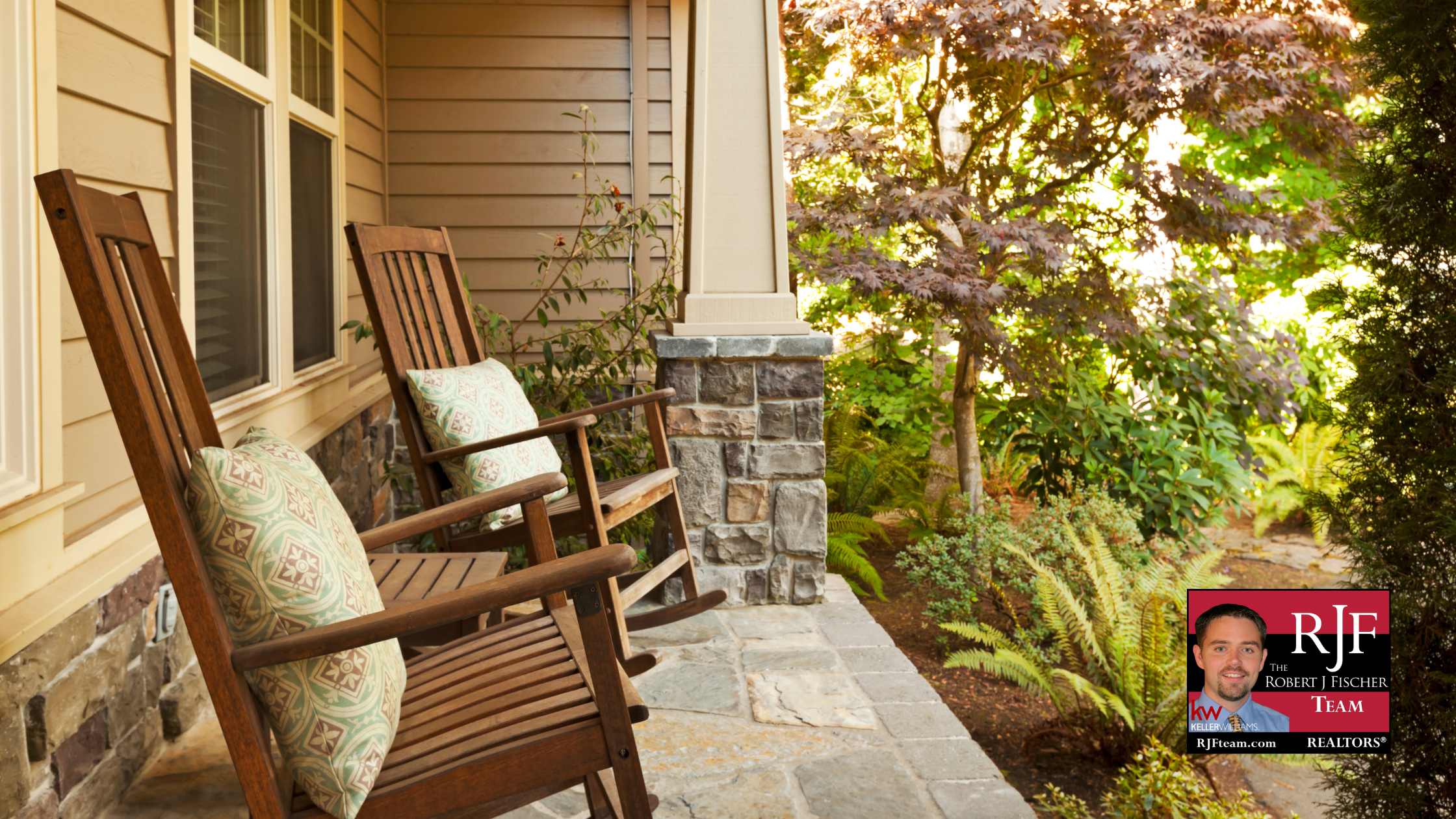 Two rocking chairs on a fall front porch with the Robert J Fischer Team logo in the bottom right corner