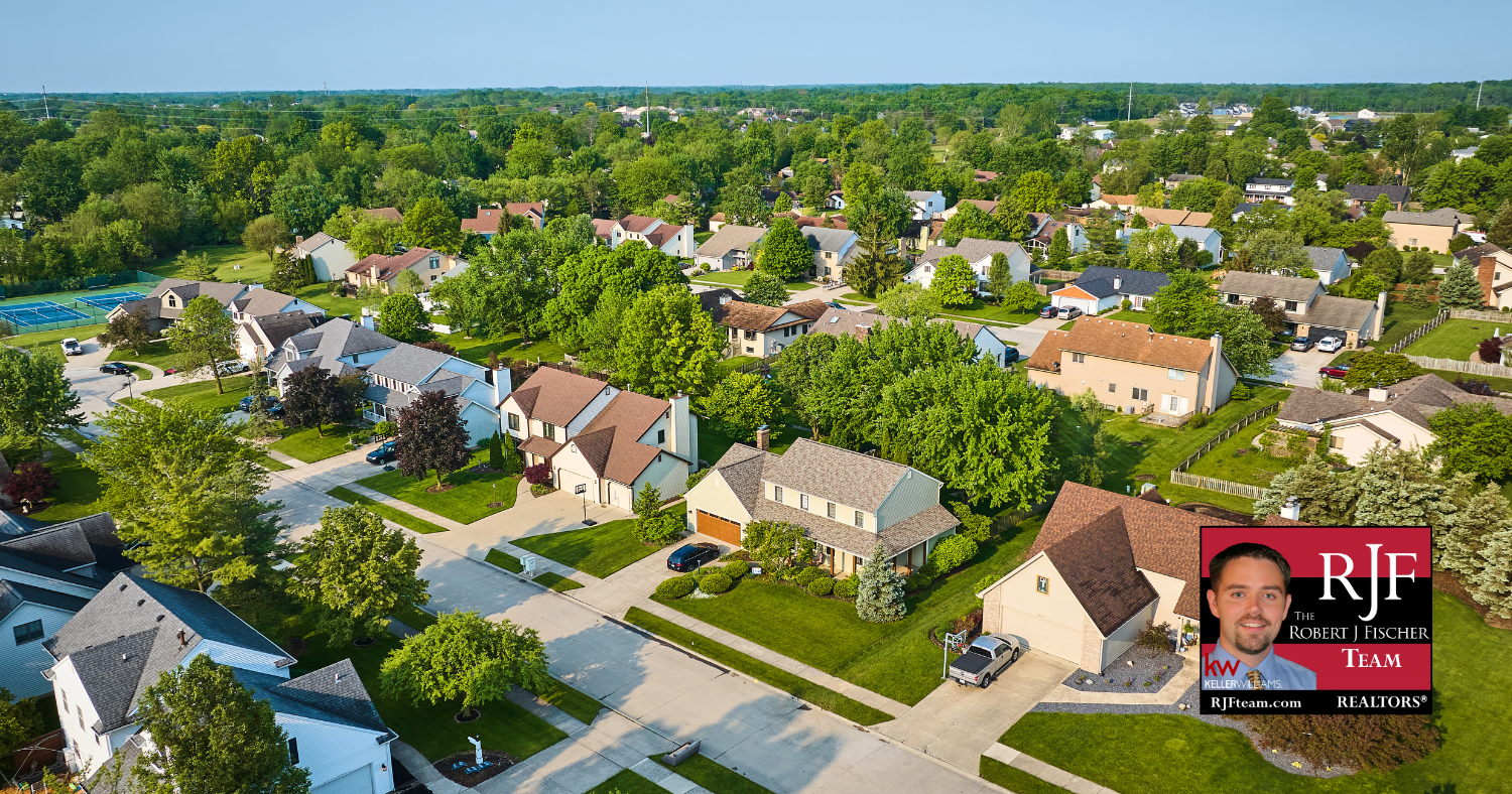 An aerial neighborhood shot of Round Rock, TX with the Robert J Fischer Team logo in the bottom right corner